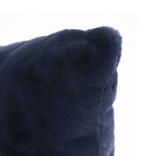 Close-up of a dark navy blue faux fur or sheepskin textured cushion corner against a plain white background.