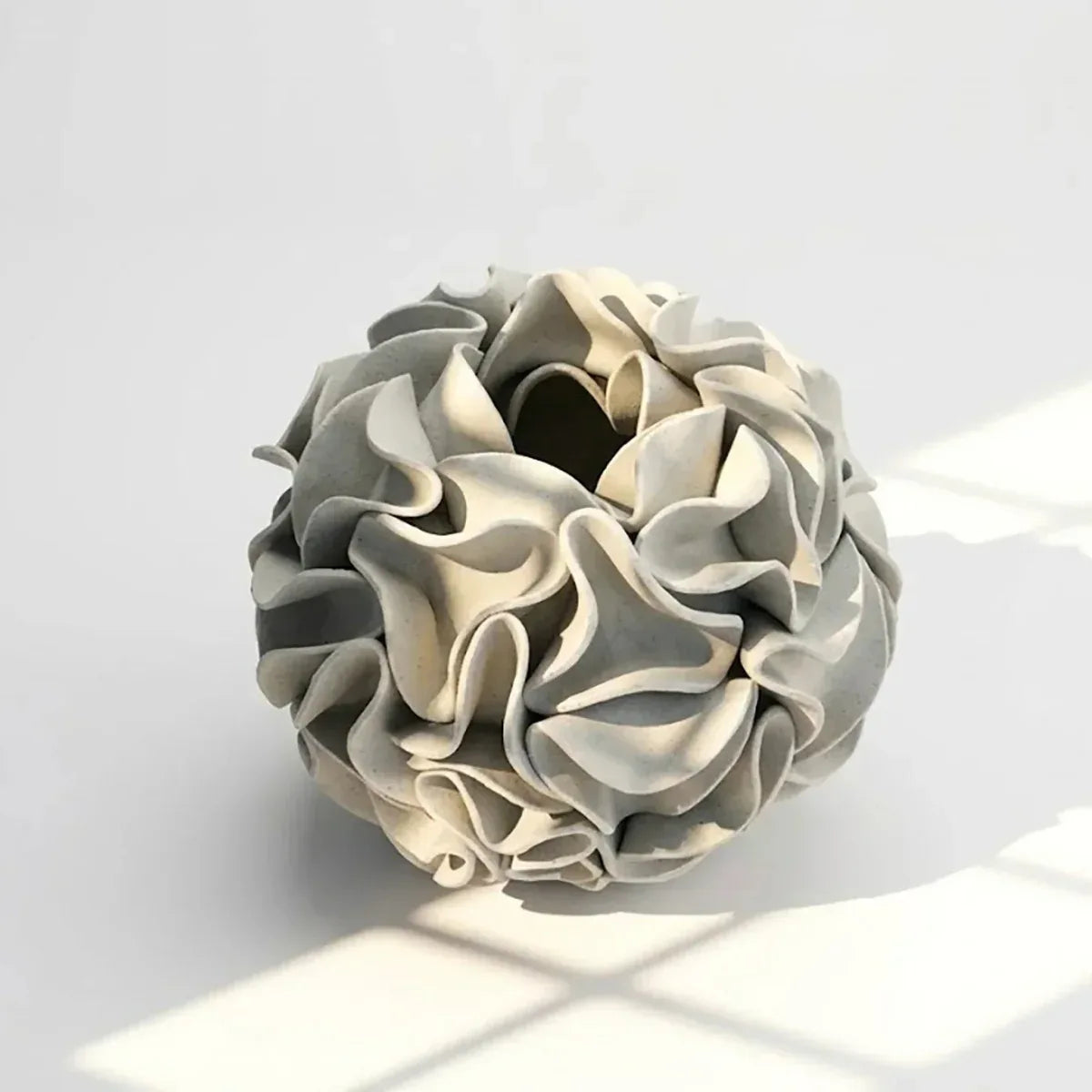 White clay ceramic flower vase sculpture with contoured edges
