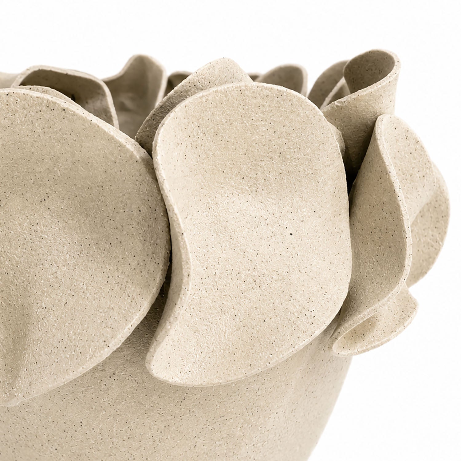 A close-up of a textured, speckled beige ceramic planter with layered, petal-like protruding rims.