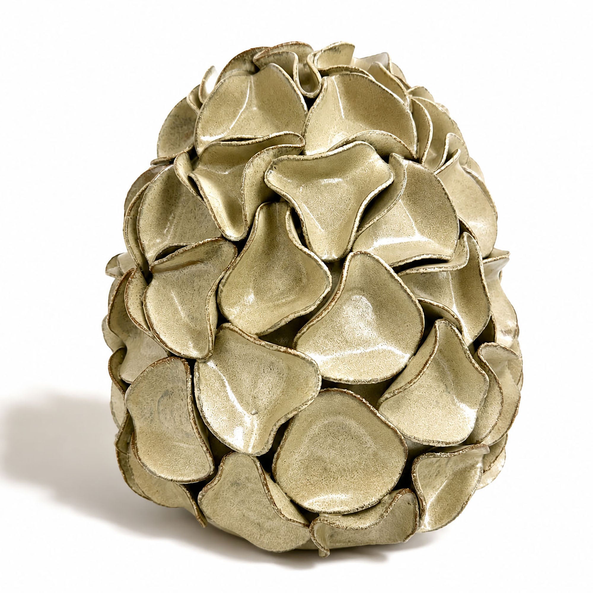 A very large decorative ceramic sculpture resembling a stylized egg, composed of overlapping petal-like scales, shown on a plain white background. By Polly Barton