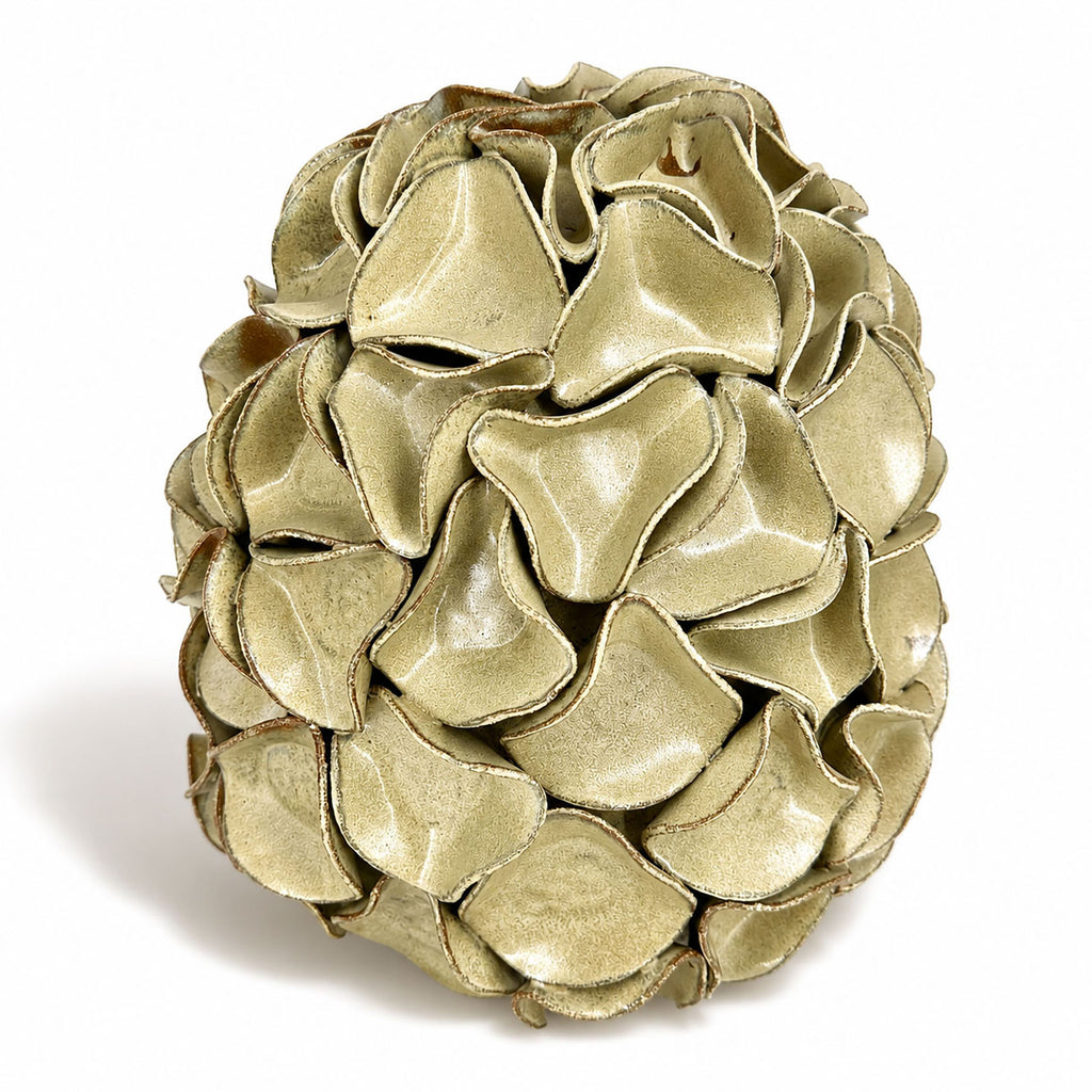 A sculptural egg-shaped decorative vase in melted mint glaze, overlapping petal-like surface folds.