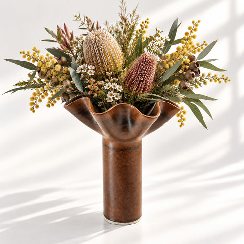 Hand-built ceramic flower vase in a rich chocolate brown glaze, featuring a sculptural ruffled rim and elegant cylindrical form