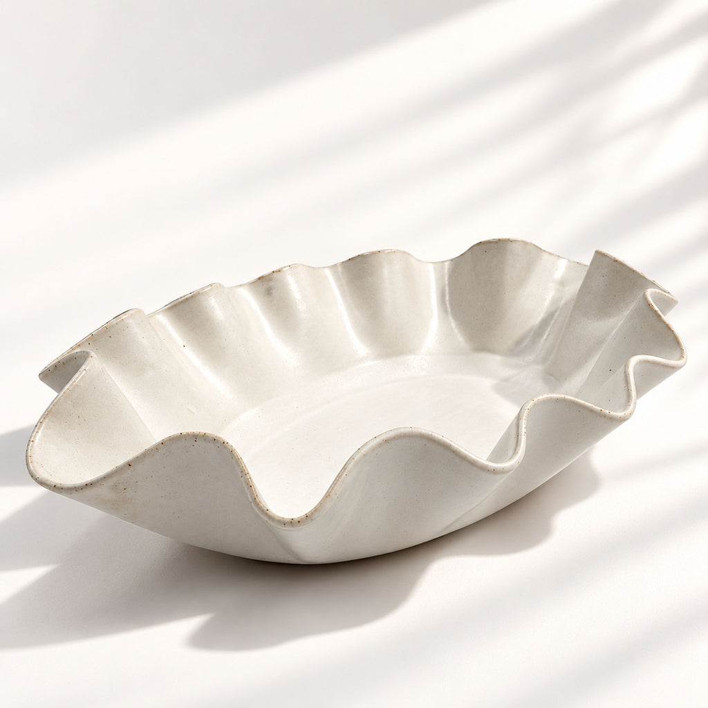 Sculptural white ceramic fruit or serving bowl, handcrafted with a flowing wave-shaped edge and a beautiful organic form