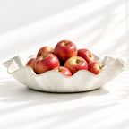 Hand-built white ceramic serving bowl featuring a sculptural wave rim, soft curves and flat base