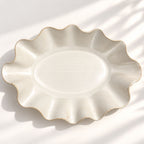 Large handmade stoneware serving bowl in a white satin glaze, with an elegant undulating rim inspired by coastal waves