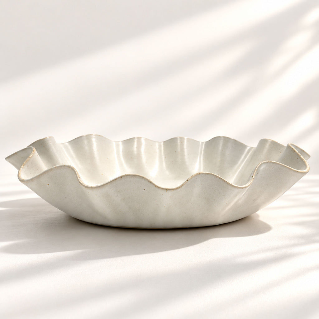 Large handmade stoneware serving bowl in a white satin glaze, with an elegant undulating rim inspired by coastal waves