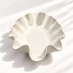 Sculptural white ceramic fruit or serving bowl, handcrafted with a flowing wave-shaped edge and a beautiful organic form