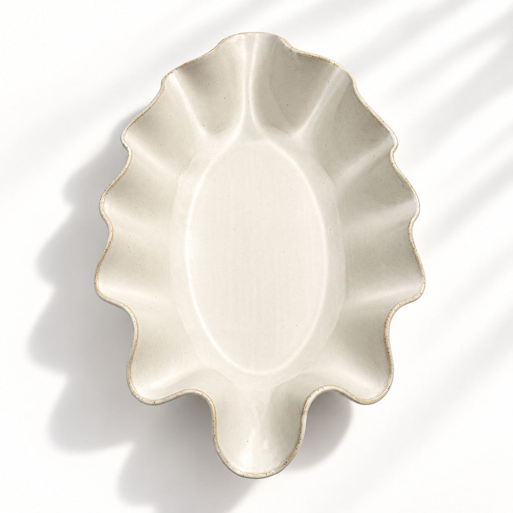 Sculptural white ceramic fruit or serving bowl, handcrafted with a flowing wave-shaped edge and a beautiful organic form