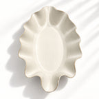 Sculptural white ceramic fruit or serving bowl, handcrafted with a flowing wave-shaped edge and a beautiful organic form